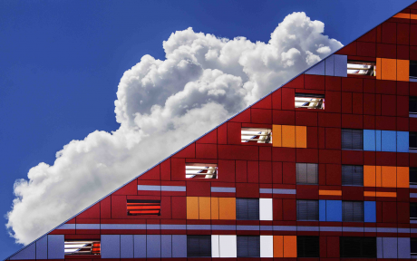 Triangular red building against white clouds and blue sky - Photo by Ivan Cujic from Pexels
