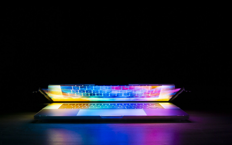 Partially open laptop emanating colored light - Image by Joshua Woroniecki from Pixabay