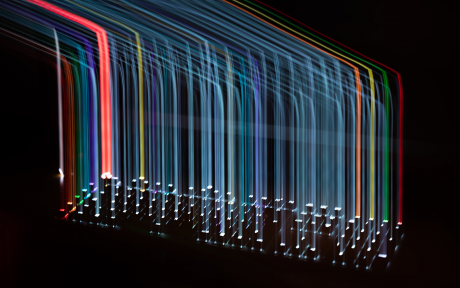 Multi-colored vertical light bars streaming from a keyboard - Photo by Adrien VIN on Unsplash