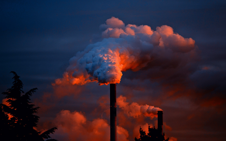cloud of orange-red smoke from smokestack against dark blue sky - image by Jurgen from Pixabay