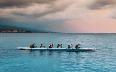 Rowers in ocean with pink sky, Photo by Ian Stauffer on Unsplash