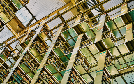 Library stacks with glass ceiling; Photo by Girl with red hat on Unsplash