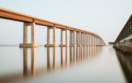 Bridge reflecting in water; Photo by Chris Briggs on Unsplash