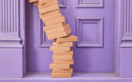 Packages at a purple door – Photo by Curology on Unsplash
