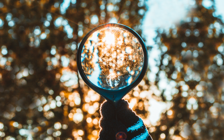 Magnifying glass with frost and sunlight; Photo by Nong on Unsplash