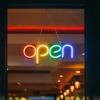 Rainbow colored neon open sign in store window - Photo by Viktor Forgacs on Unsplash